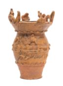 A Chinese pottery vase Qing Dynasty the barrel shaped body applied with rudimentary animals and