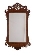 A parcel gilt walnut framed wall mirror in George II style,