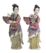 Two Chinese famille rose figures of maidens, probably Republic wearing elaborate floral robes,