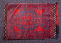 An Afghanistan grain bag, the red field with a quartered octagon, within a cruciform lozenge border,