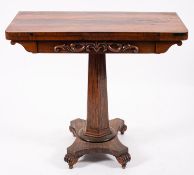 A George IV rosewood games table, circa 1825; the hinged top with rounded front edges,