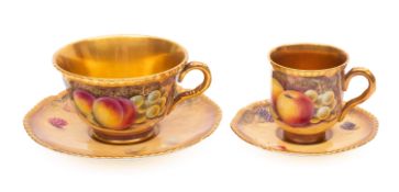 A Royal Worcester porcelain teacup and saucer plus coffee cup and saucer both painted by Peter