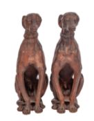 A pair of Continental, probably Austrian terracotta models of seated hounds,