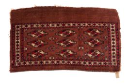 A Tekke Turkoman Juval, the shaded wine field with three rows of shaped and quartered medallions,