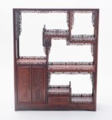 A set of Chinese carved hongmu hardwood table-top display shelves with fret carved 'galleries',
