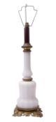 A milk glass and gilt metal mounted table oil lamp,