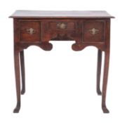 A George II oak 'lowboy' side table, circa 1745; the rectangular top with moulded edges,
