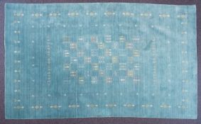 A Contemporary wool rug, the pastel blue field with geometric designs and lozenge motif border,