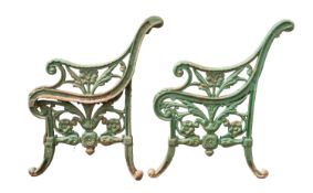 A pair of green painted cast iron bench ends,