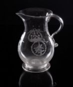 A Masonic glass jug of baluster form with strap handle and tooled terminal the flanks engraved with