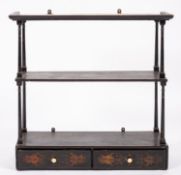 A set of Regency black lacquered wood wall shelves,