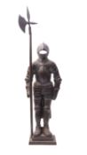 A cast iron fireside companion stand modelled as a standing knight in armour, early 20th century,