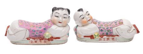 A pair of Chinese porcelain wrist rests each in the form of a crouching boy and girl,