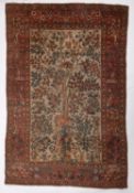 A Qum rug, the ivory field with a design of birds amidst flowering trees and shrubs,