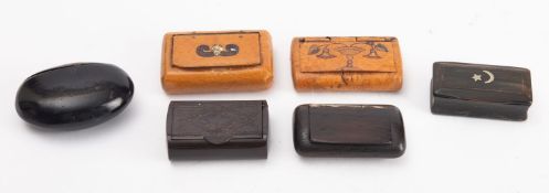 A collection of various snuff boxes, including wooden,