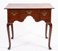 A George II oak lowboy, mid 18th Century; the rectangular top with moulded edges,