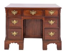 A late George II /George III mahogany kneehole desk, circa 1760; the top with moulded edges,