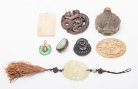 A mixed group of Chinese carved jade and other hard stone pendants and tablets, variously carved,