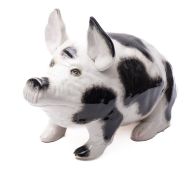 A large Wemyss Ware pottery pig painted and sponged in black and grey, two feet tinted pink,
