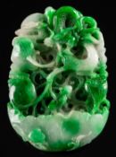 A large Chinese jadeite 'lotus and dragon' pendant carved and pierced with a scaly dragon amongst