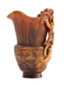 A Chinese archaistic carved buffalo horn libation cup with relief carved chilong handle,