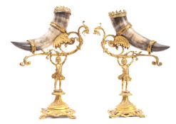 A pair of gilt metal and horn table centrepieces modelled as girls supporting cornucopias,