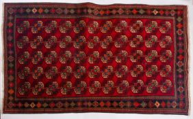 A Turkoman rug, the wine field with an all over design of quartered octagons,