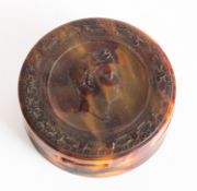 A tortoiseshell circular box press moulded with a profile bust of Napoleon Bonapart,