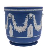 A Wedgwood pale blue jasper ware jardiniere sprigged with classical figures beneath swags of