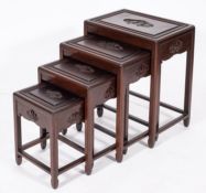 A Chinese stained hardwood nest of four occasional tables,