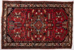 A Hamadan rug, the brick red field with a central powder blue stellar pole medallion,