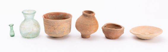 Four pieces of Indus pottery, comprising a lamp, two dishes and a vase,