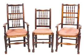 An associated set of nine early 19th Century ash, beech and fruitwood spindle back dining chairs,