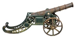A cast iron cannon in Victorian style, 20th Century; the 39 inch knopped barrel with rounded breech,