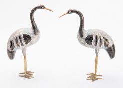 A pair of Chinese cloisonné cranes with red crowns and black, white and blue plumage, 28cm high.