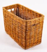 A large wickerwork log bin,