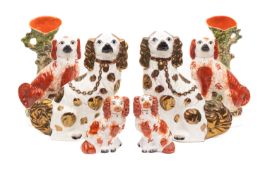 Three pairs of Staffordshire spaniels, each in seated posture,