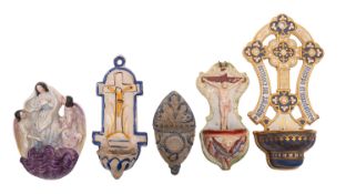 Five various holy water stoops, comprising a pearl ware example,