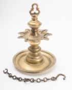 An Indian brass lamp with flower shaped pan for nine wicks above a broad circular drip pan,