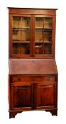 An oak and glazed bureau bookcase in Geo