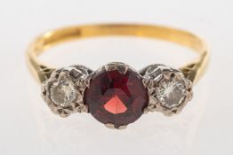 A three stone garnet and diamond ring, c