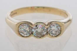 A three stone diamond ring, collet set t