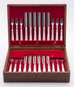 An early 20th century oak cased set of t