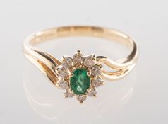 An emerald and diamond cluster ring,
