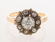 An antique diamond cluster ring, of openwork flowerhead form,