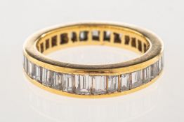 A baguette-cut diamond full eternity ring,