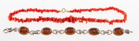 An amber bracelet and a coral necklace, a bracelet set with five amber cabochons,