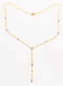 An 18ct yellow and white gold diamond lariat style necklace, of twisted links,