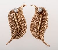 A pair of diamond leaf clip on earrings, circa 1960's, each earring is of rope twist leaf form,