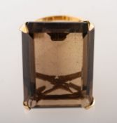 A 1970's 9ct gold smokey quartz cocktail ring, claw set with a rectangular-cut smokey quartz,